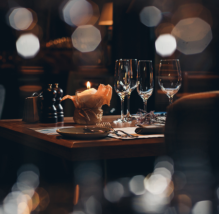 Dining table set with candle and wine glasses